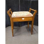 An Edwardian oak piano stool.