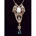 An Art Nouveau style silver pendant necklace set with opalite and a topaz drop.