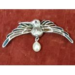 A silver and plique a jour brooch with a pearl drop in the form of a bird.