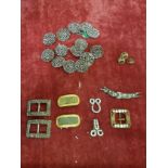 A bag of antique buckles and brooches.