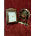 A single wall mounted quartz clock with a hidden key compartment and one other.