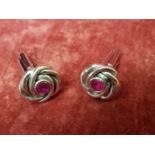 A pair of silver and jubilate cufflinks.