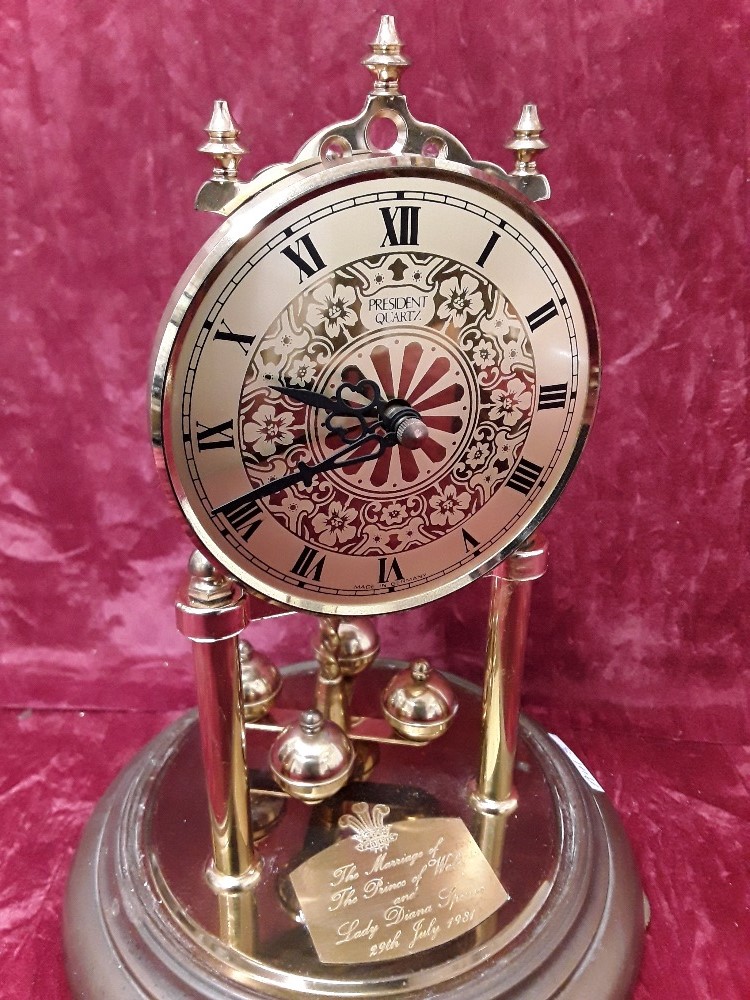 A revolving pendulum glass domed mantel clock with two brass supports. - Image 2 of 2