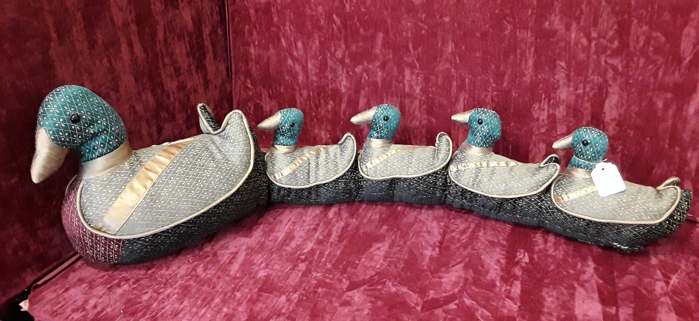 A draught excluder in the form of a row of ducks.