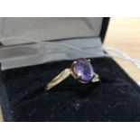 A 9ct yellow gold ring set with amethyst gem stone.