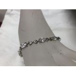 A silver and CZ line bracelet.