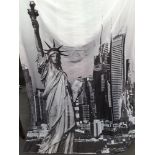 One long black and white fine polyester curtain with large silver coloured hanging rings.