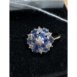 A 9ct yellow gold ring set with seven diamonds and 12 tanzanite gem stones.