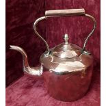 A large heavy Victorian copper kettle.