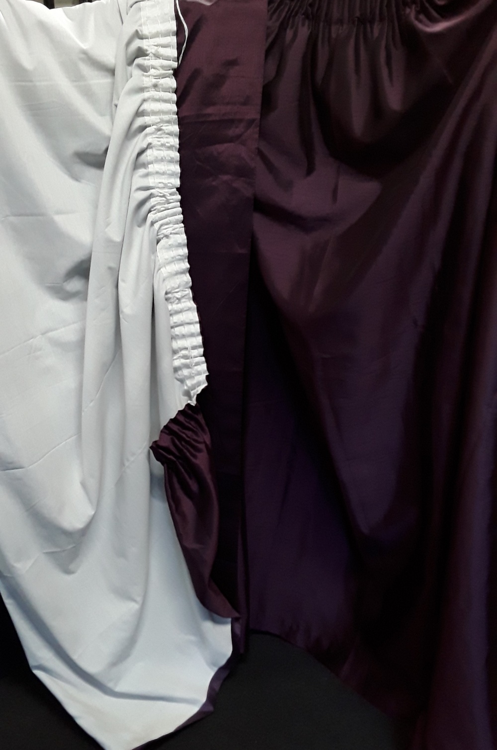 A pair of purple polyester fully lined curtains.