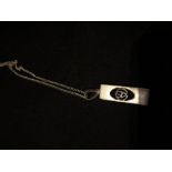 A silver pendant necklace in the style of Charles Rennie Mackintosh.