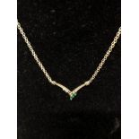 A beautiful 14K necklace set with three diamonds and three emeralds.