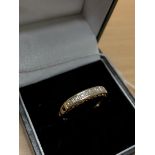 A 9ct yellow gold ring with hearts on mount and set with seven diamonds.