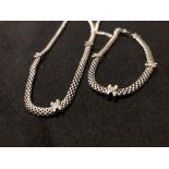 A silver articulating necklace and bracelet set.