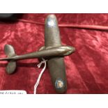 A bronze car mascot in the form of an early monoplane, possibly French.