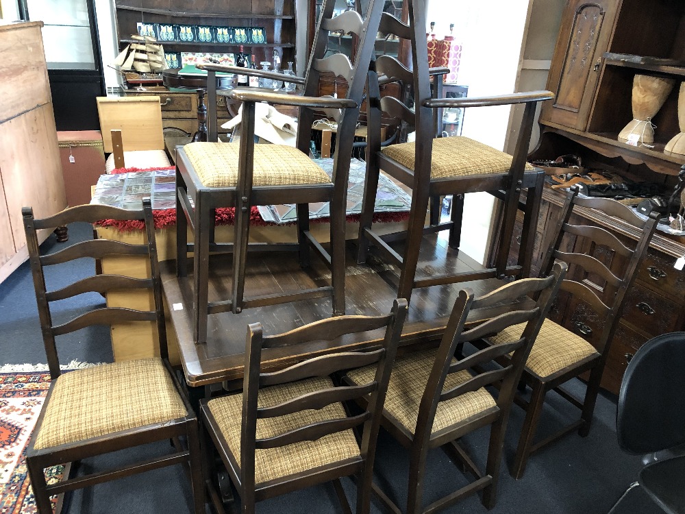 A small oak Art Deco style Ercol extending dining room table with six chairs.