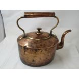 A large antique copper kettle.