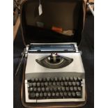 A cased Imperial typewriter in its brown leather carry case.