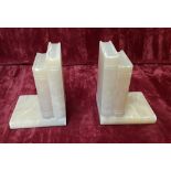 A pair of quartz book ends sculpted in the form of books.