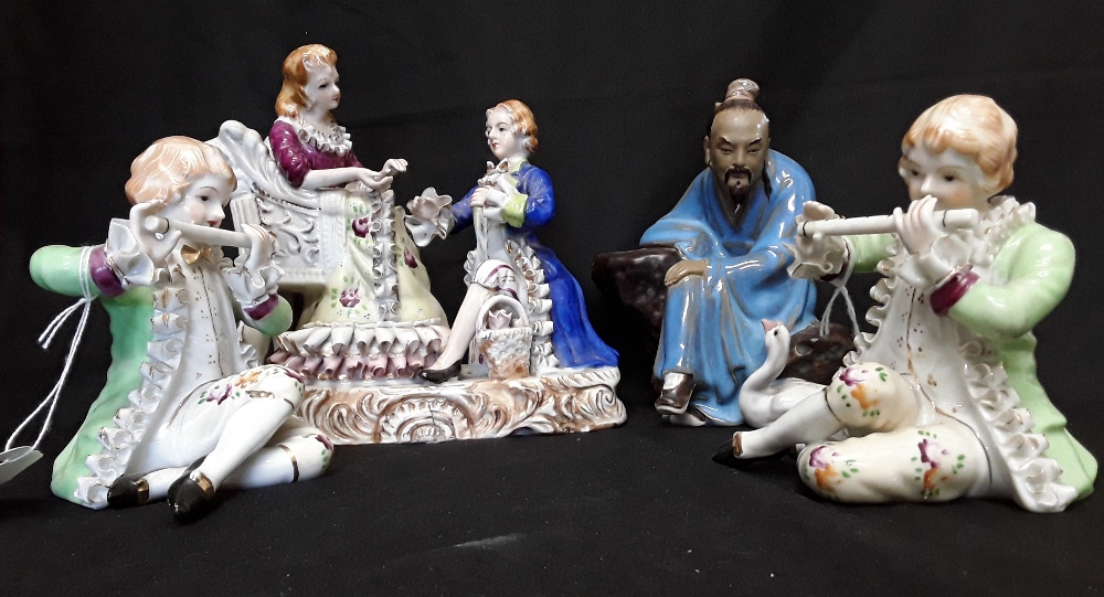 A collection of four porcelain and ceramic figurines.