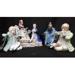 A collection of four porcelain and ceramic figurines.