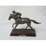 A figurine of the racehorse Shergar with rider.