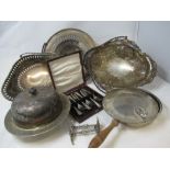 A collection of silver plate serving dishes including a muffin dish, boxed cake forks, etc.