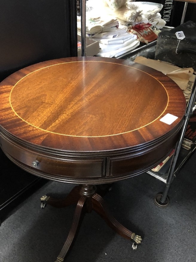 A mahogany circular drum table with two drawers.