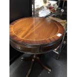 A mahogany circular drum table with two drawers.