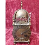 A small brass Empire style mantel clock.