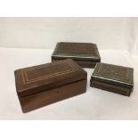 A collection of three wooden boxes and two folding rulers.