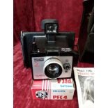 A Polaroid camera in case. Includes manual.