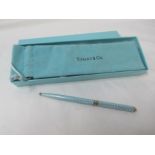 A Tiffany silver and pale blue enamel pen in soft pouch and box.