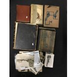 A collection of photograph albums, framed and loose photographs and a family Bible.