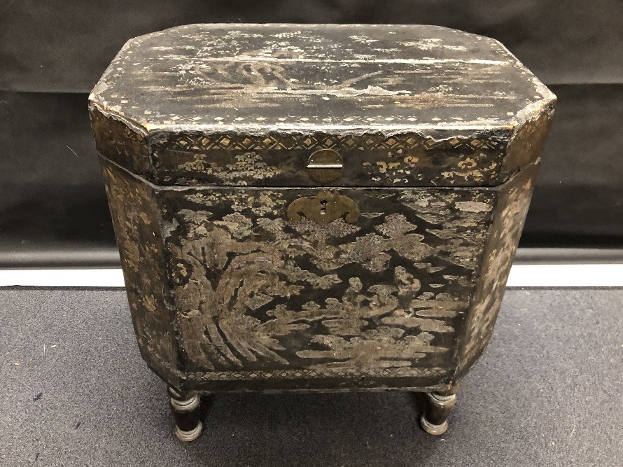 An ebonised lidded sheet music box with inlaid mother of pearl depicting traditional Chinese scenes.