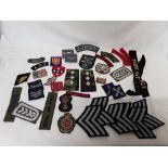 A quantity of assorted embroidered cloth military badges.