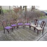 A set of six oak chairs (2 plus 4), with Queen Anne style backs.