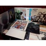 A small collection of historic albums and records reflecting a history of music and style.