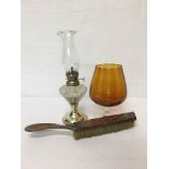 A copper topped clothes brush together with a glass oil lamp and a small balloon glass.