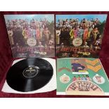 Two copies of The Beatles ‘Sgt. Peppers Lonely Hearts Club Band’ . One has 'A day in the life's omit