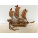 A handcrafted wooden model of a Chinese junk.