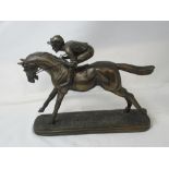 A figurine of a racehorse and rider.