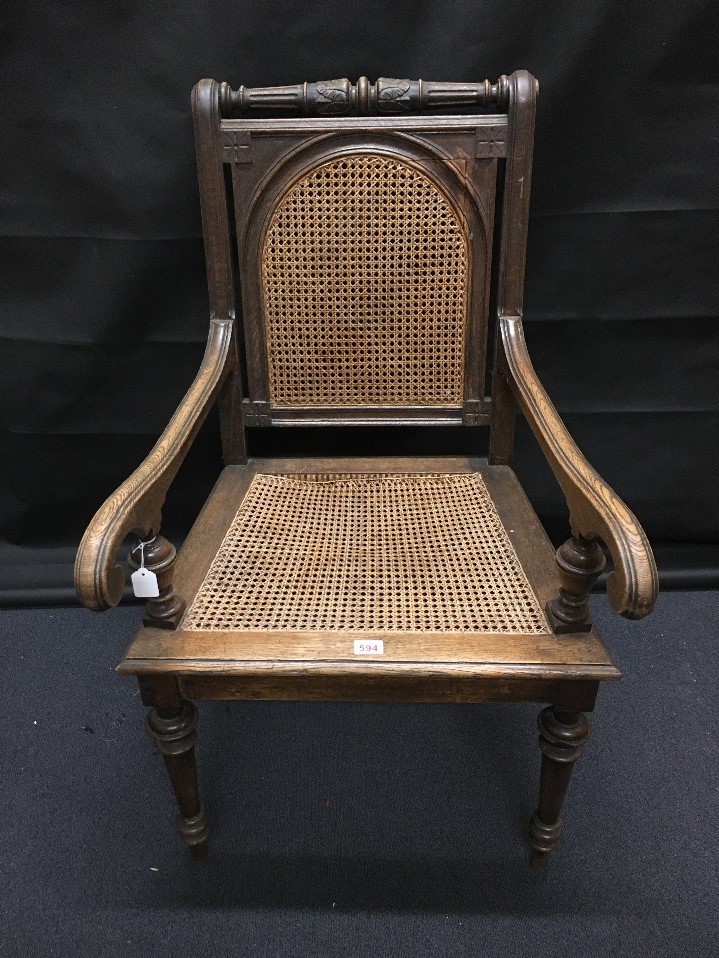 A large 19th Century German arm chair with wicker seat and back.