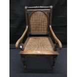 A large 19th Century German arm chair with wicker seat and back.