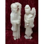 A pair of white soapstone figurines.