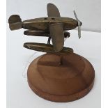 A trench art brass model of a Schneider Trophy seaplane with spinning propeller.