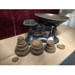 A set of kitchen scales complete with pan and a variety of imperial weights.