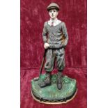 A heavy cast iron door stop in form of a golfer.