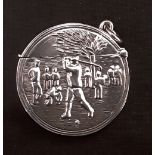 A silver vesta case embossed with the image of a golfer.