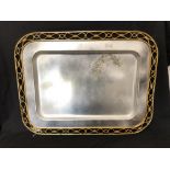 A large vintage silver plated tray with gold coloured decoration to the edge